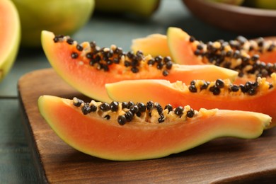 Photo of Fresh sliced papaya fruit on table, closeup