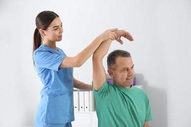 Doctor working with patient in hospital. Rehabilitation physiotherapy