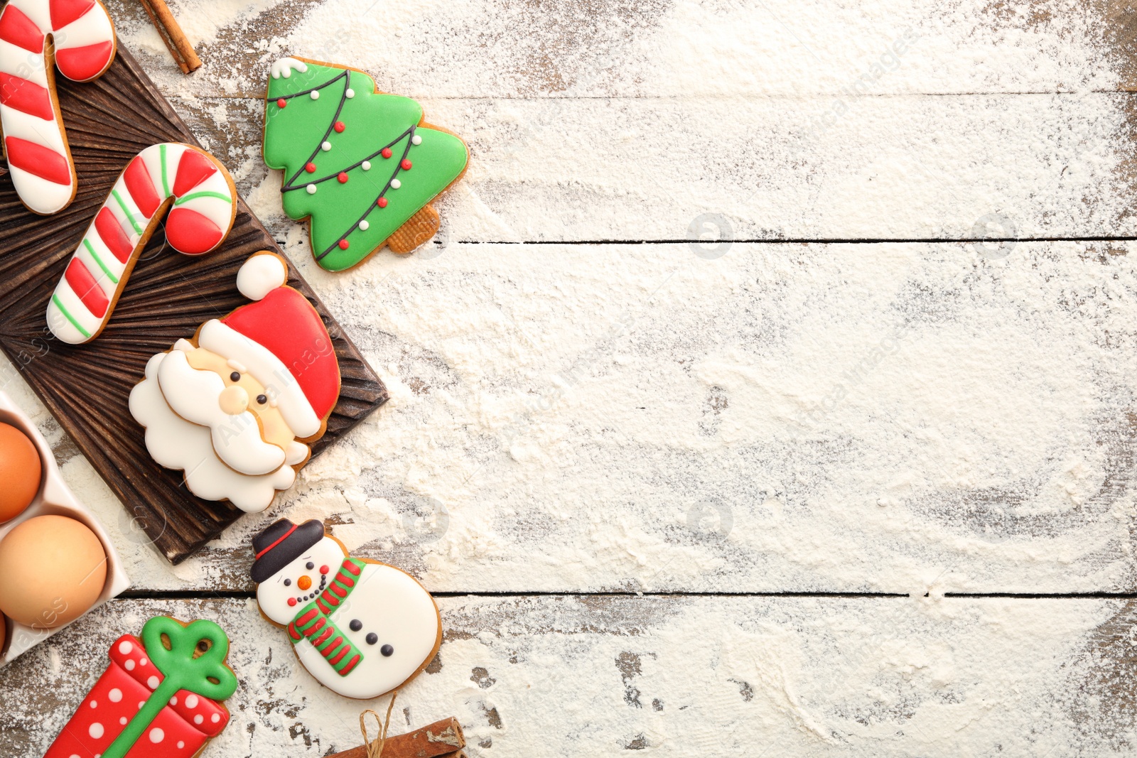 Photo of Flat lay composition with delicious homemade Christmas cookies on wooden table. Space for text