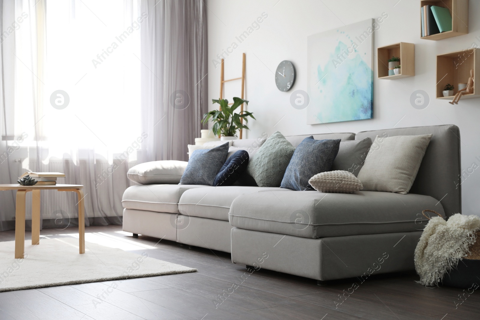 Photo of Elegant living room with comfortable sofa near window. Interior design