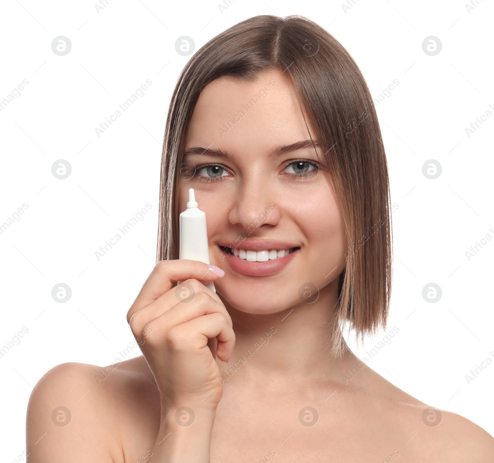 Photo of Young woman holding tube of eye cream on white background