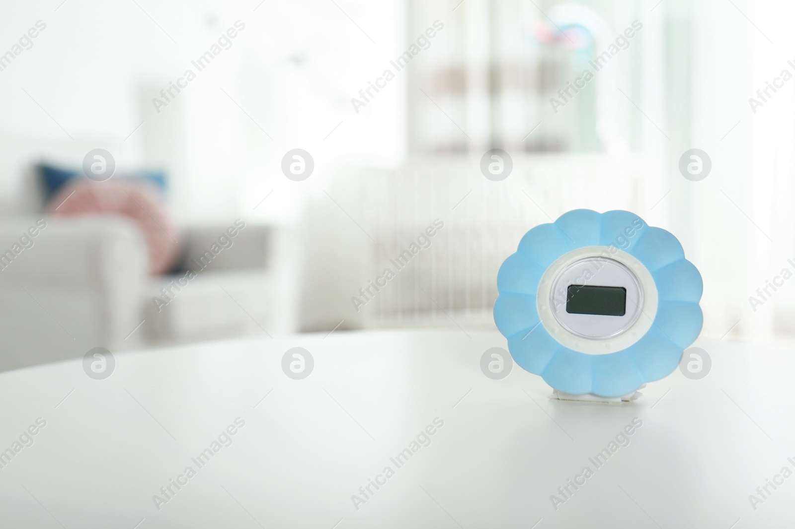 Photo of Digital temperature and humidity control in baby room interior. Space for text