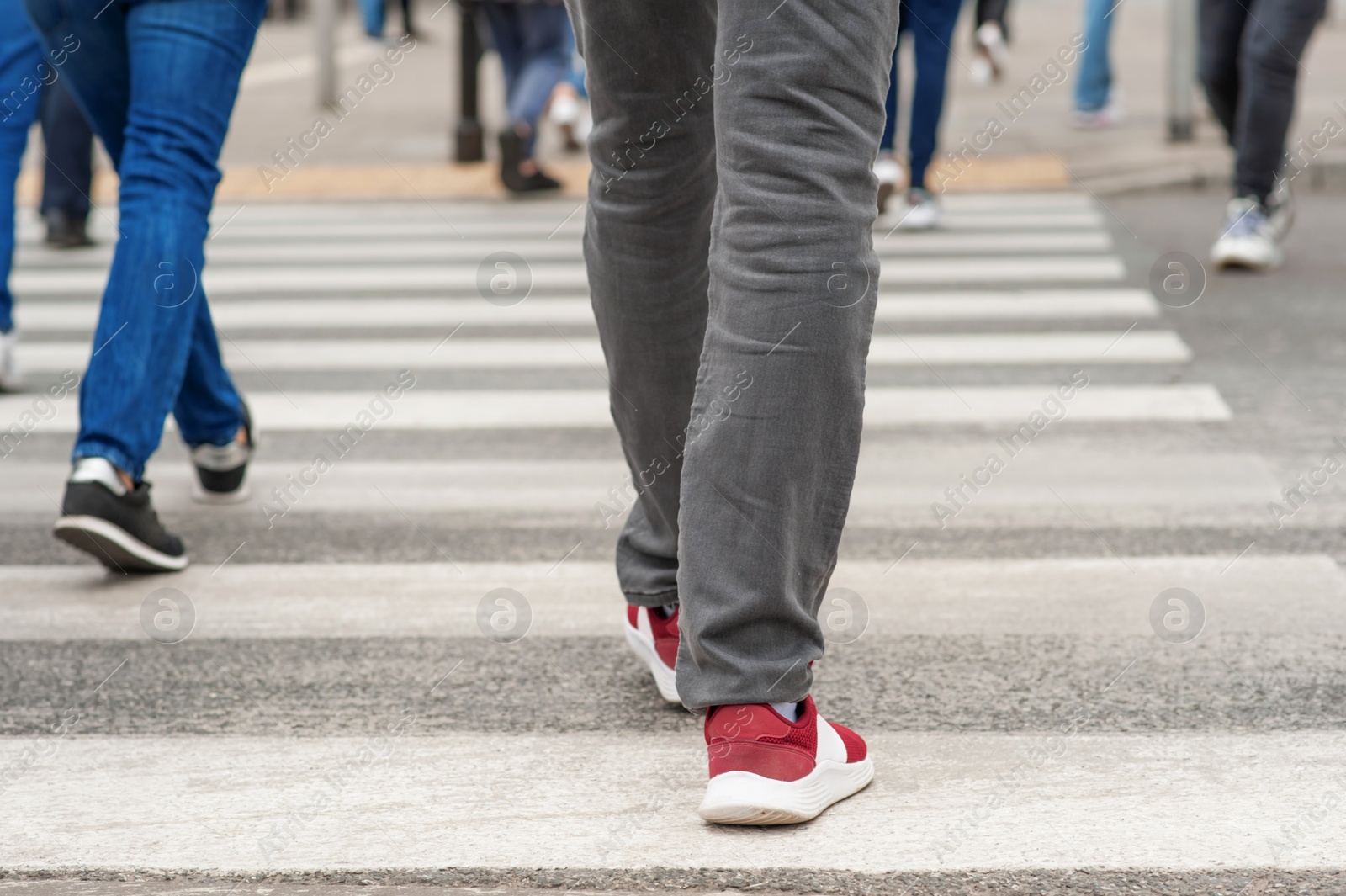 Photo of People crossing street in city, closeup view