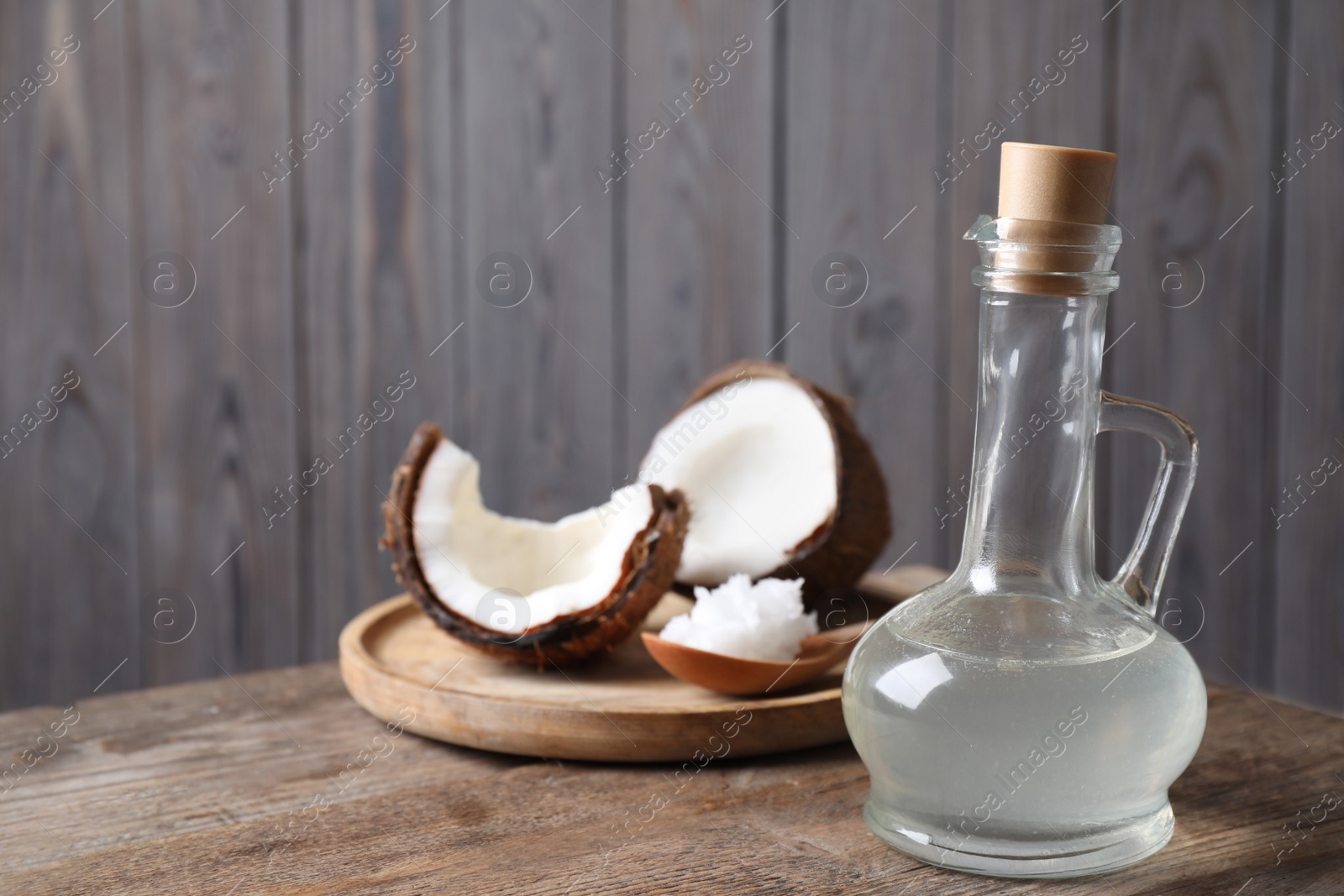 Photo of Coconut oil on wooden table. Space for text