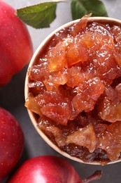 Delicious apple jam and fresh fruits on grey table, flat lay