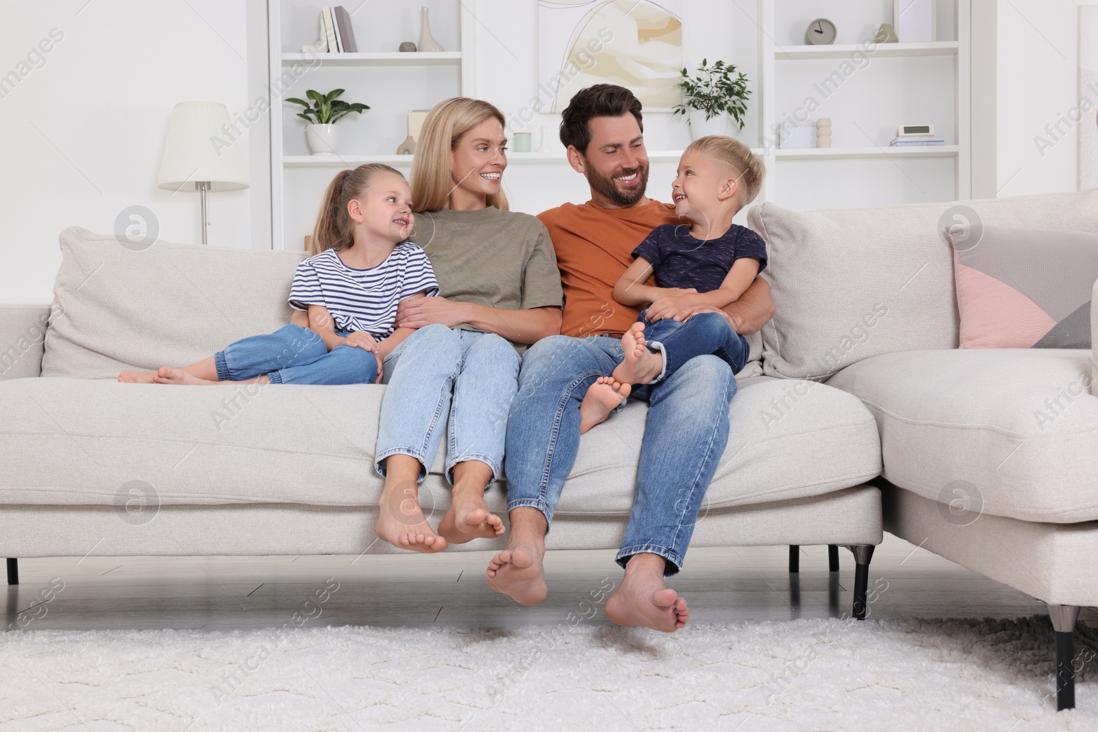 Photo of Happy family spending time together on sofa at home