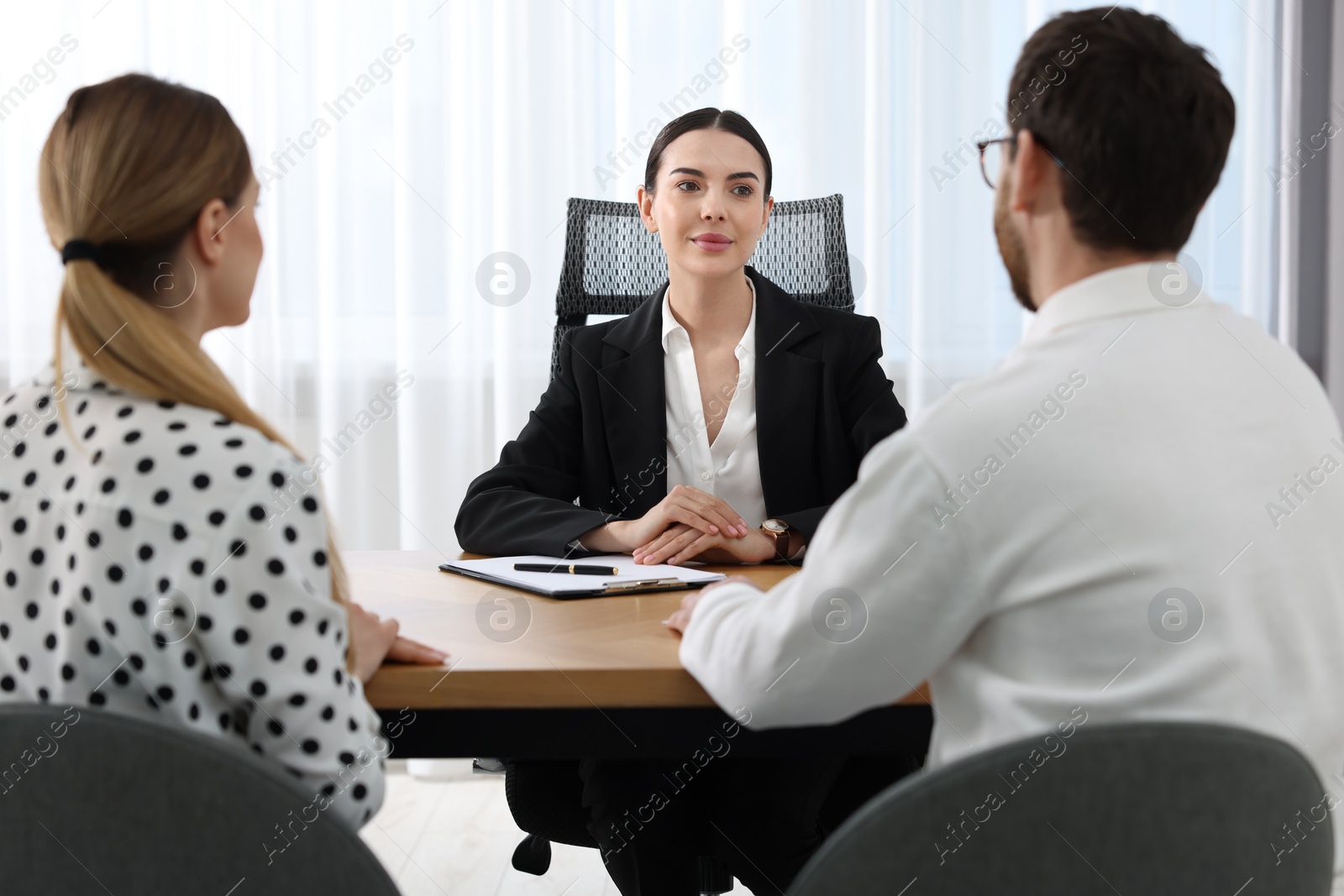 Photo of Couple having meeting with lawyer in office