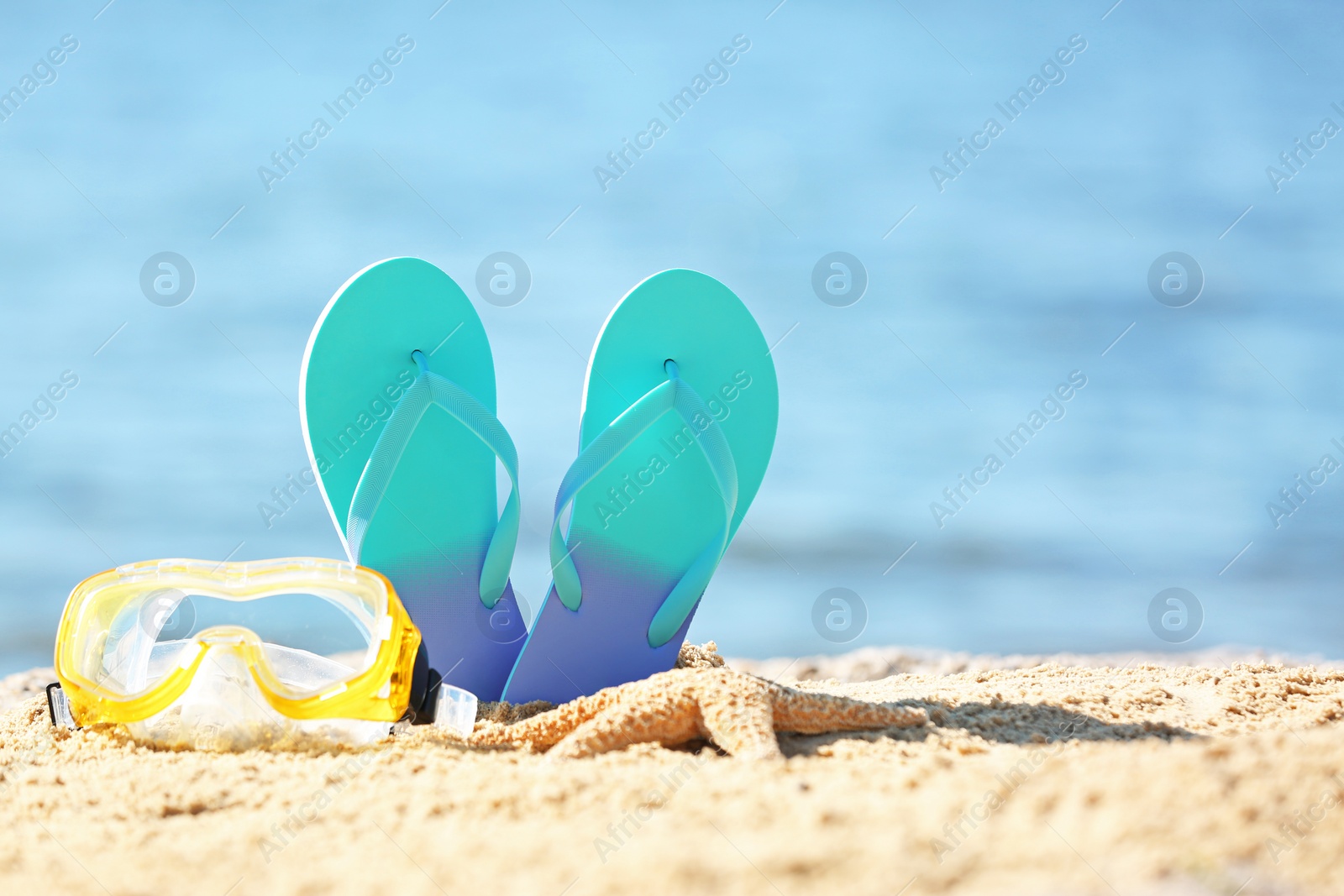 Photo of Composition with beach objects on sand against blurred background