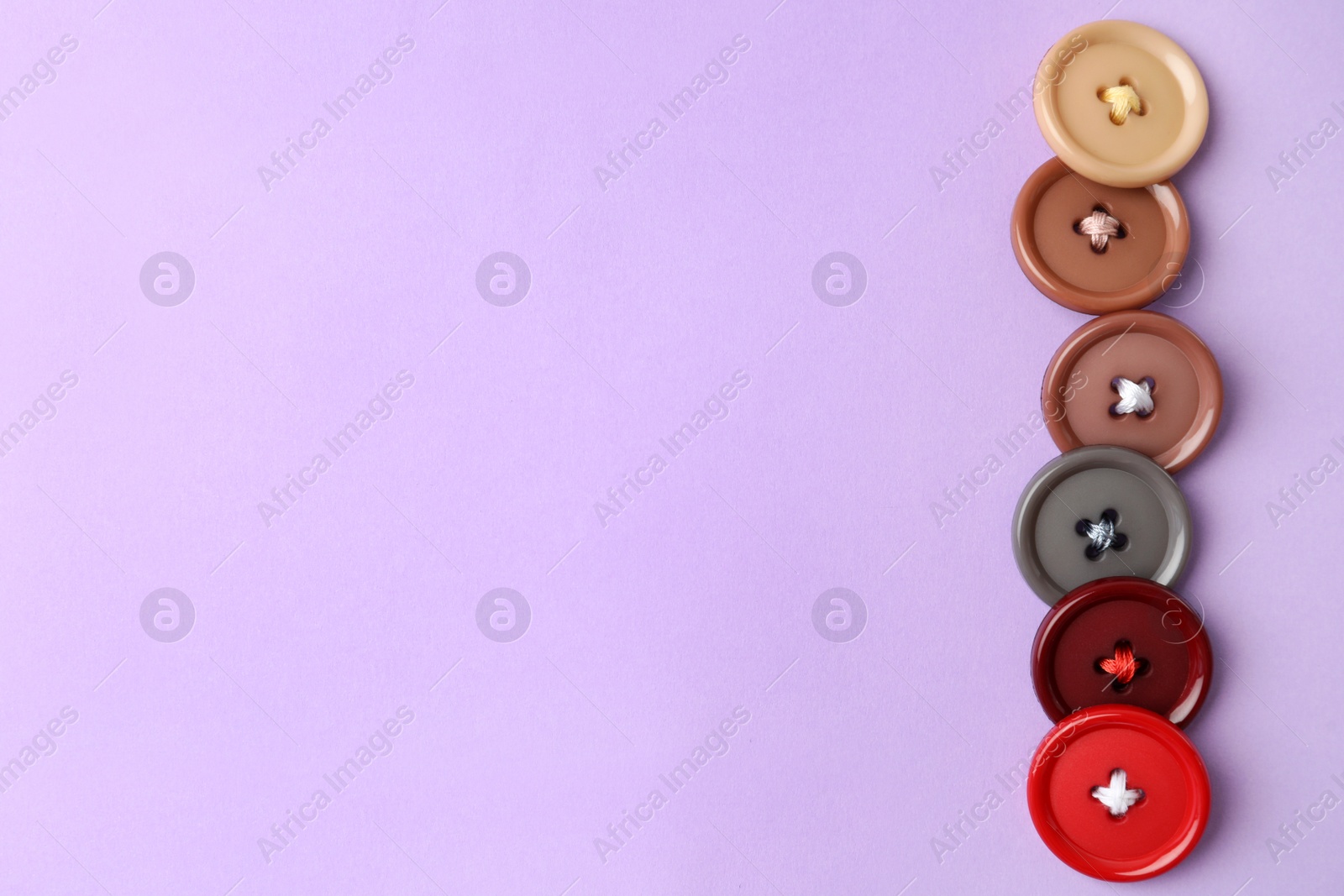 Photo of Many colorful sewing buttons on violet background, flat lay. Space for text