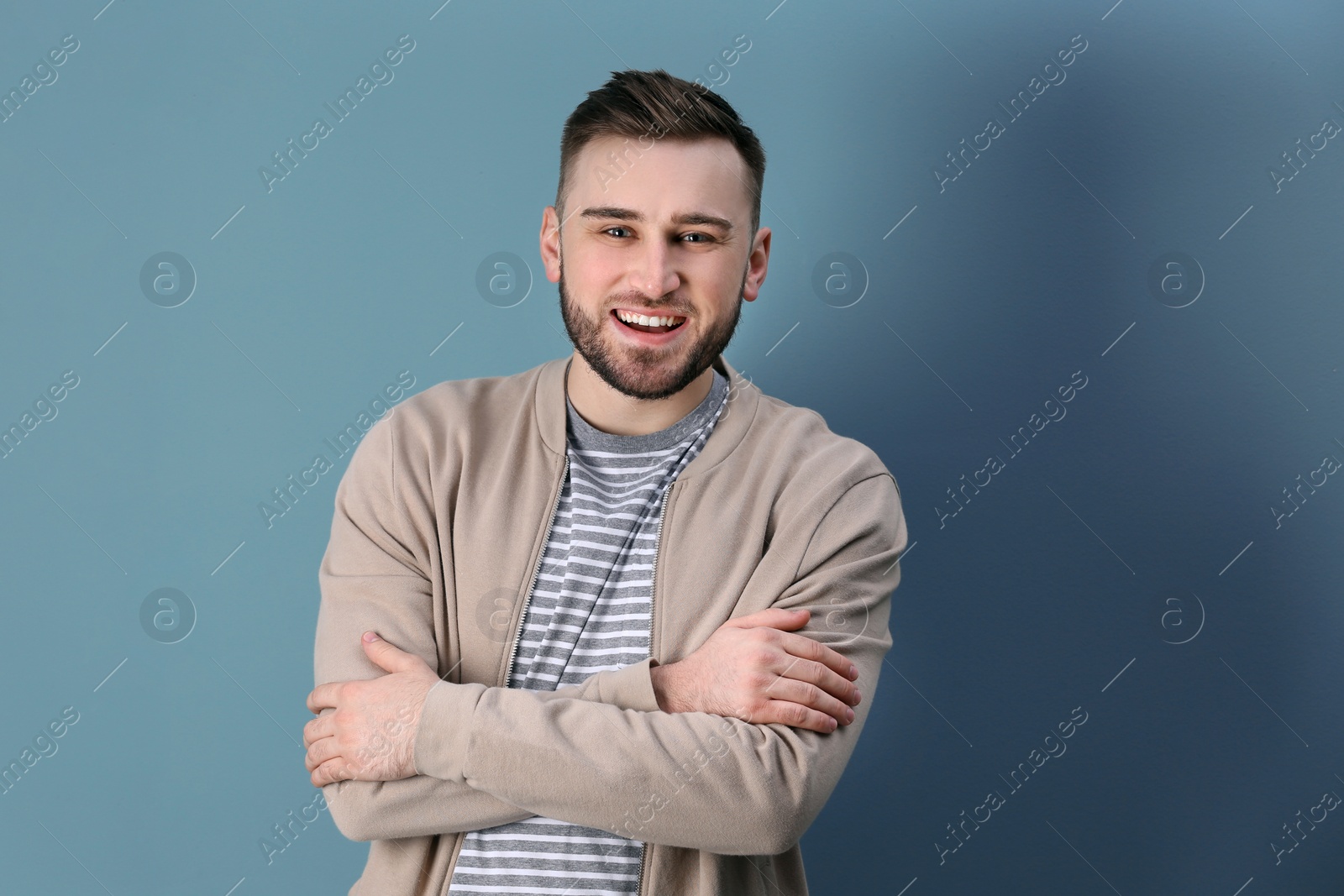 Photo of Portrait of confident young man on color background