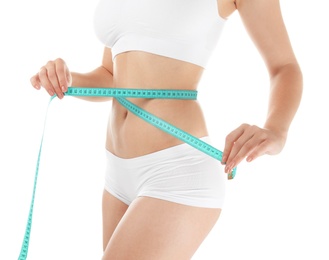 Beautiful young woman with measuring tape on white background. Healthy diet