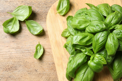 Photo of Fresh basil on wooden table, flat lay