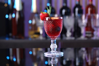 Photo of Glass of delicious refreshing sangria on counter in bar