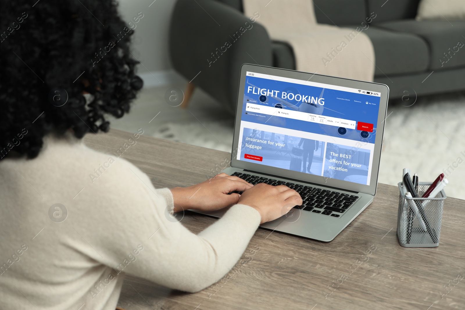 Image of Woman using laptop to book flight at home, closeup