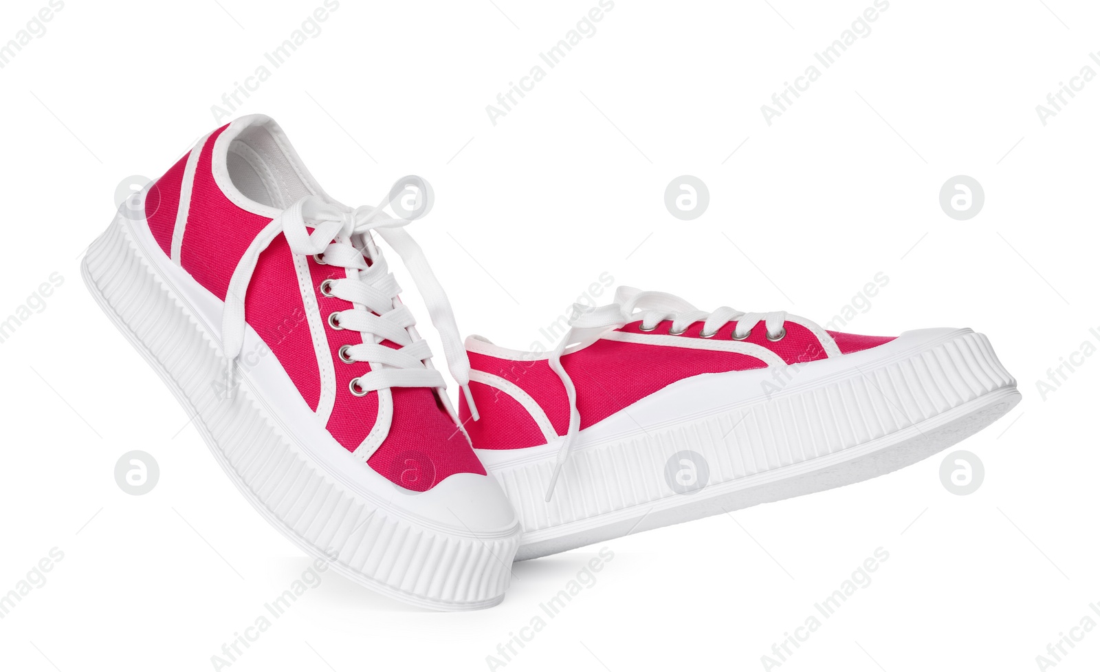 Photo of Pair of red classic old school sneakers on white background