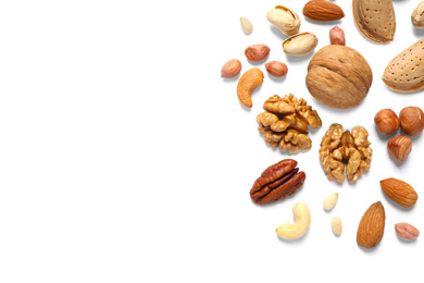 Different delicious nuts on white background, flat lay. Space for text