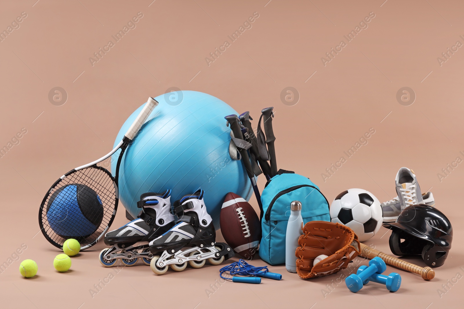 Photo of Many different sports equipment on beige background