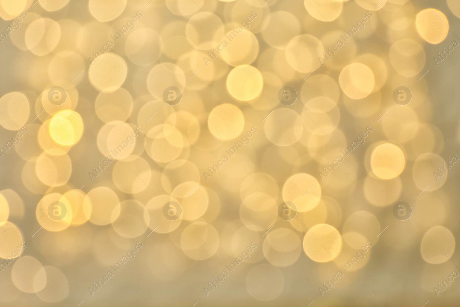 Photo of Blurred view of golden Christmas lights as background. Bokeh effect