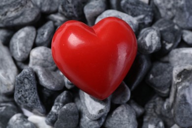 Photo of Red decorative heart on stones, closeup view