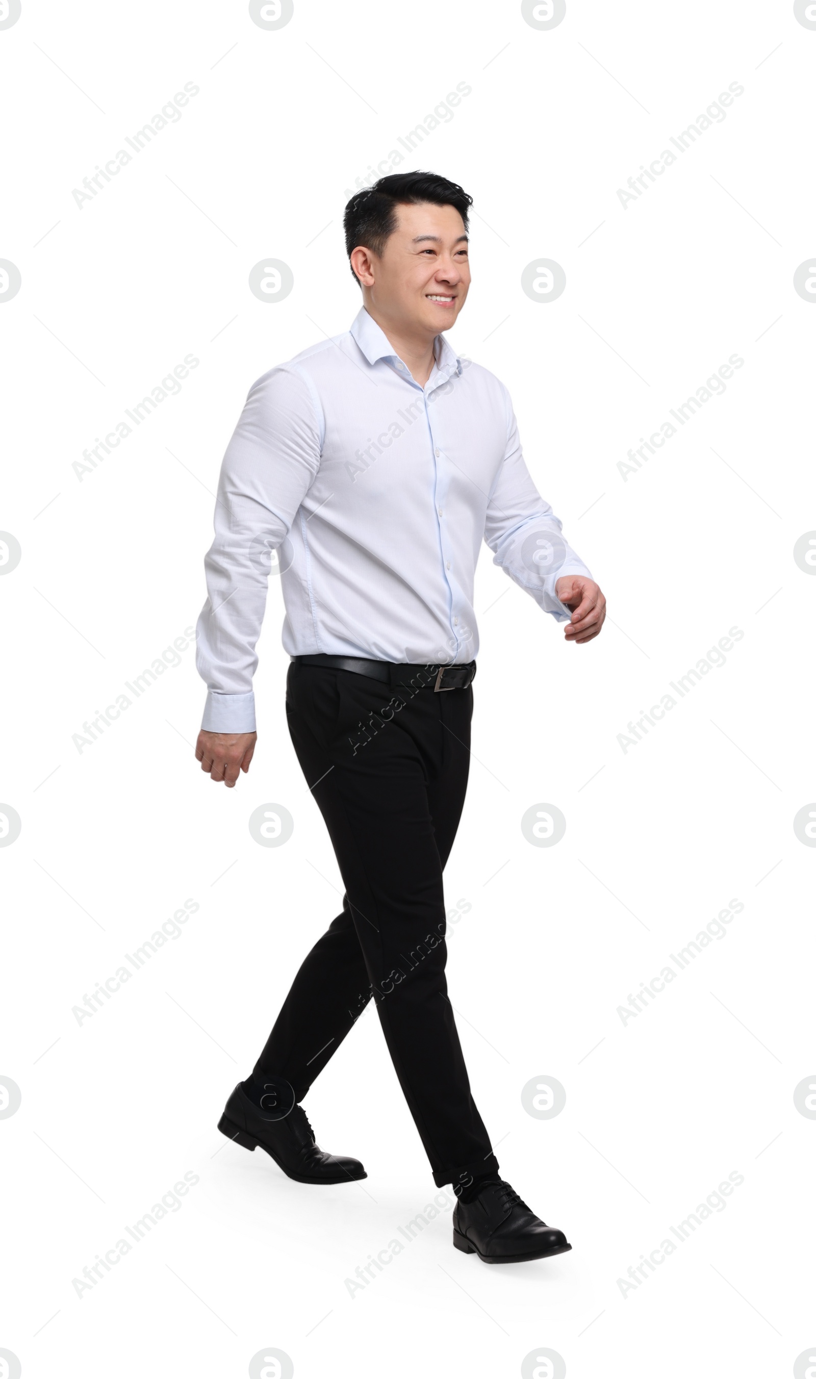 Photo of Businessman in formal clothes walking on white background