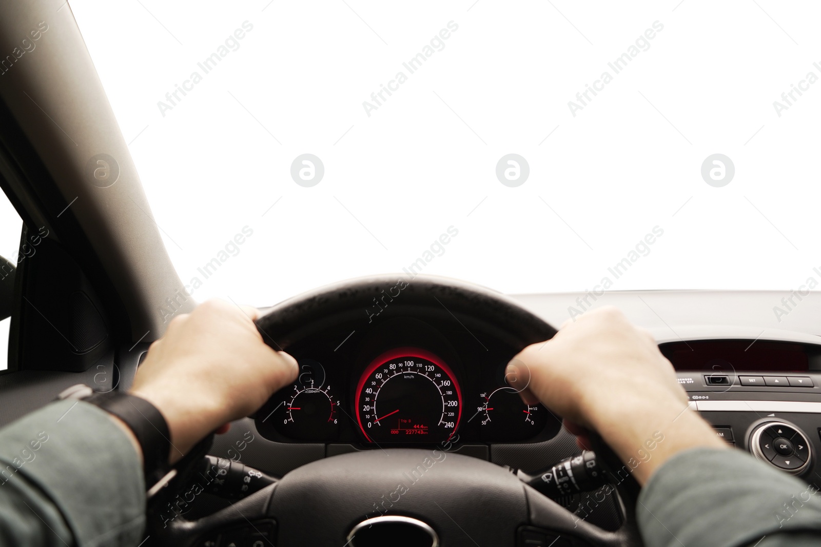 Photo of Man driving car with speedometer on dashboard, closeup