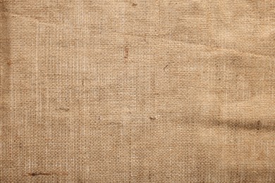 Texture of natural burlap fabric as background, top view