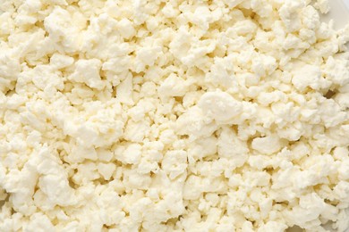 Photo of Delicious fresh cottage cheese as background, top view