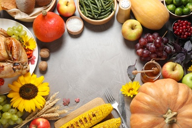 Photo of Frame made of turkey, autumn vegetables and fruits on grey background, flat lay. Happy Thanksgiving day