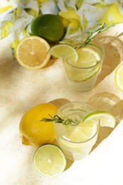 Photo of Tasty summer refreshing lemonade and ingredients on light table, above view