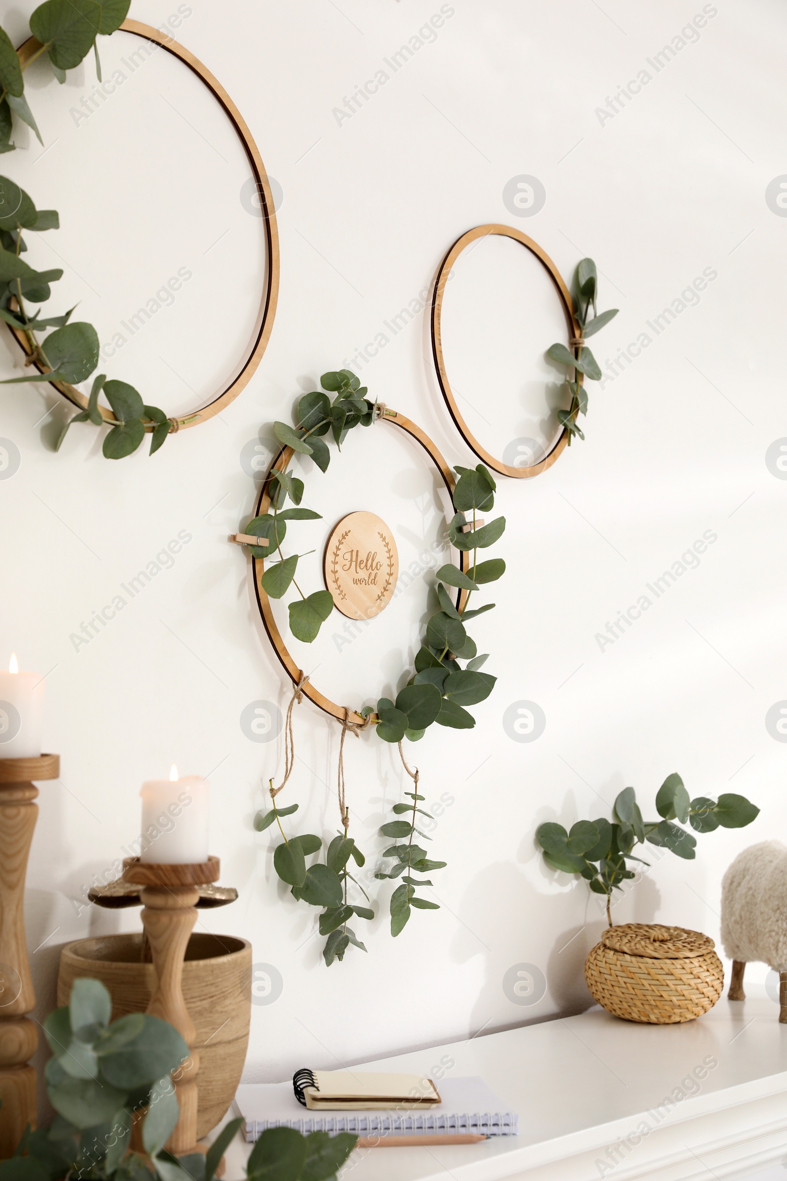 Photo of Beautiful eucalyptus decor on white wall in room. Interior element