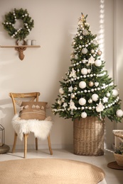 Photo of Beautiful decorated Christmas tree in festive room interior