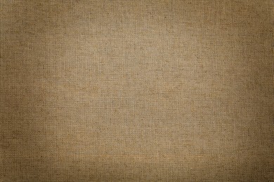 Image of Texture of natural burlap fabric as background, top view. Vignette effect 