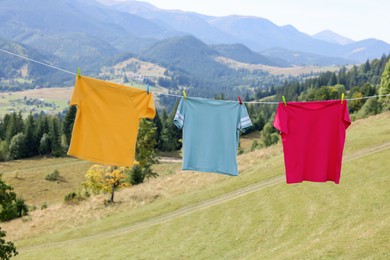 Washing line with clean laundry and clothespins in mountains