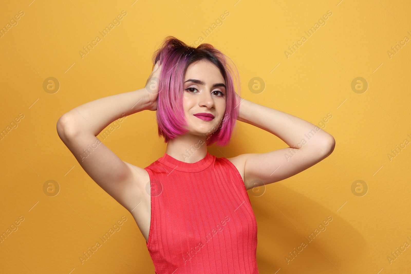 Photo of Young woman with trendy hairstyle against color background