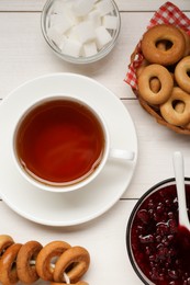 Flat lay composition with delicious ring shaped Sushki (dry bagels) and cup of tea on white wooden table