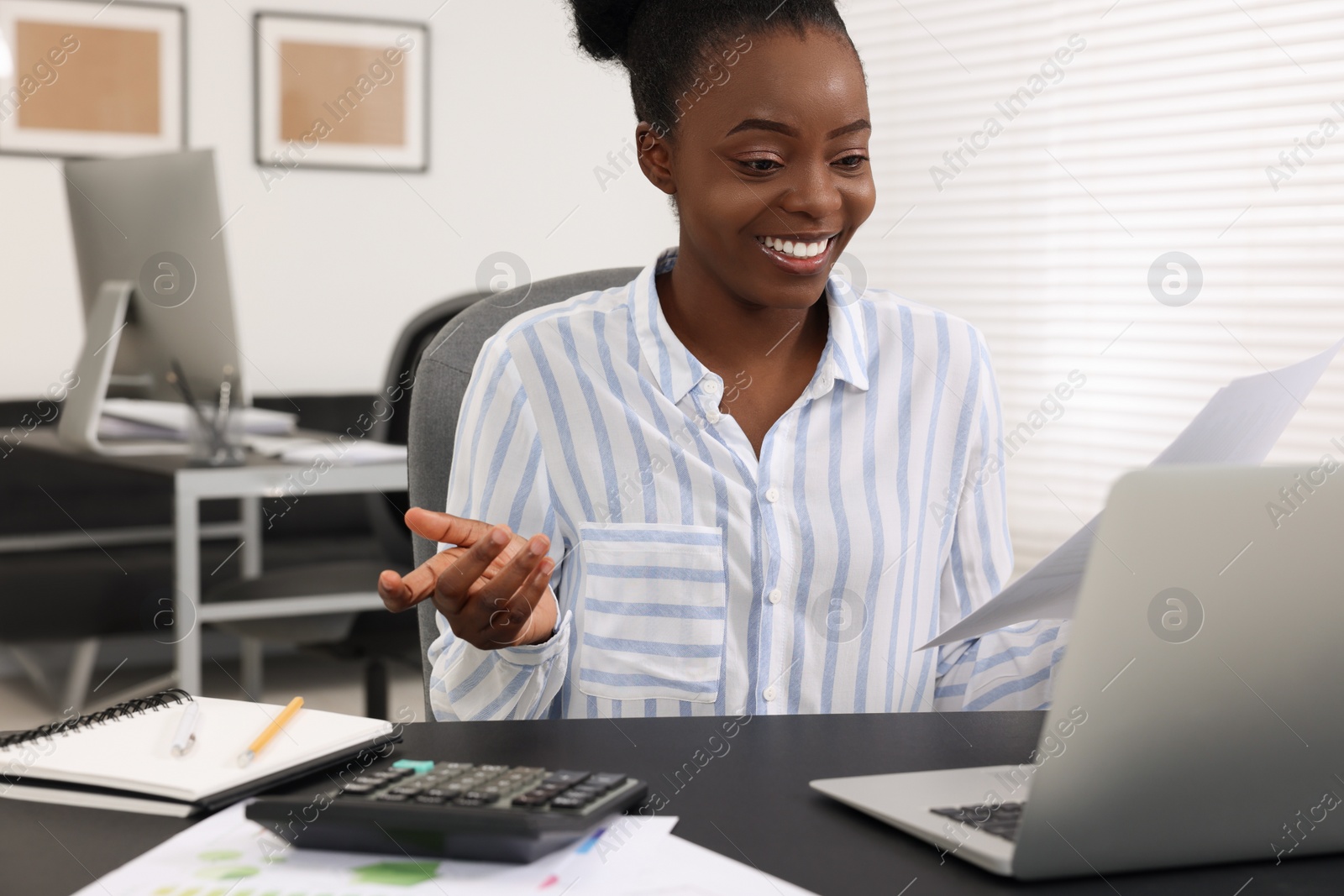 Photo of Professional accountant having video chat via computer at desk in office