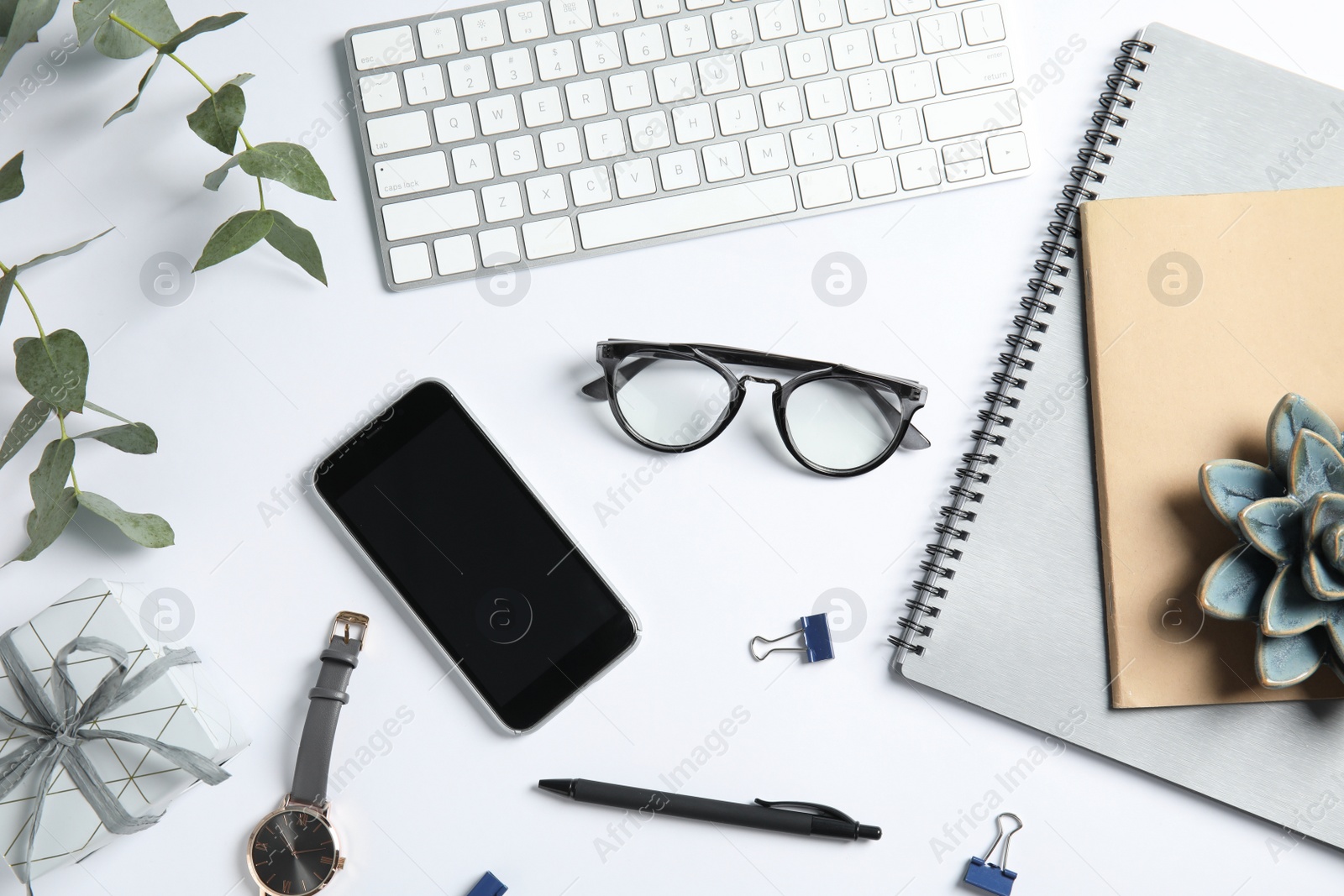 Photo of Flat lay composition with computer keyboard and mobile phone on white background. Blogger's workplace