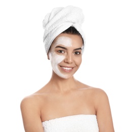 Happy young woman with organic mask on her face against white background