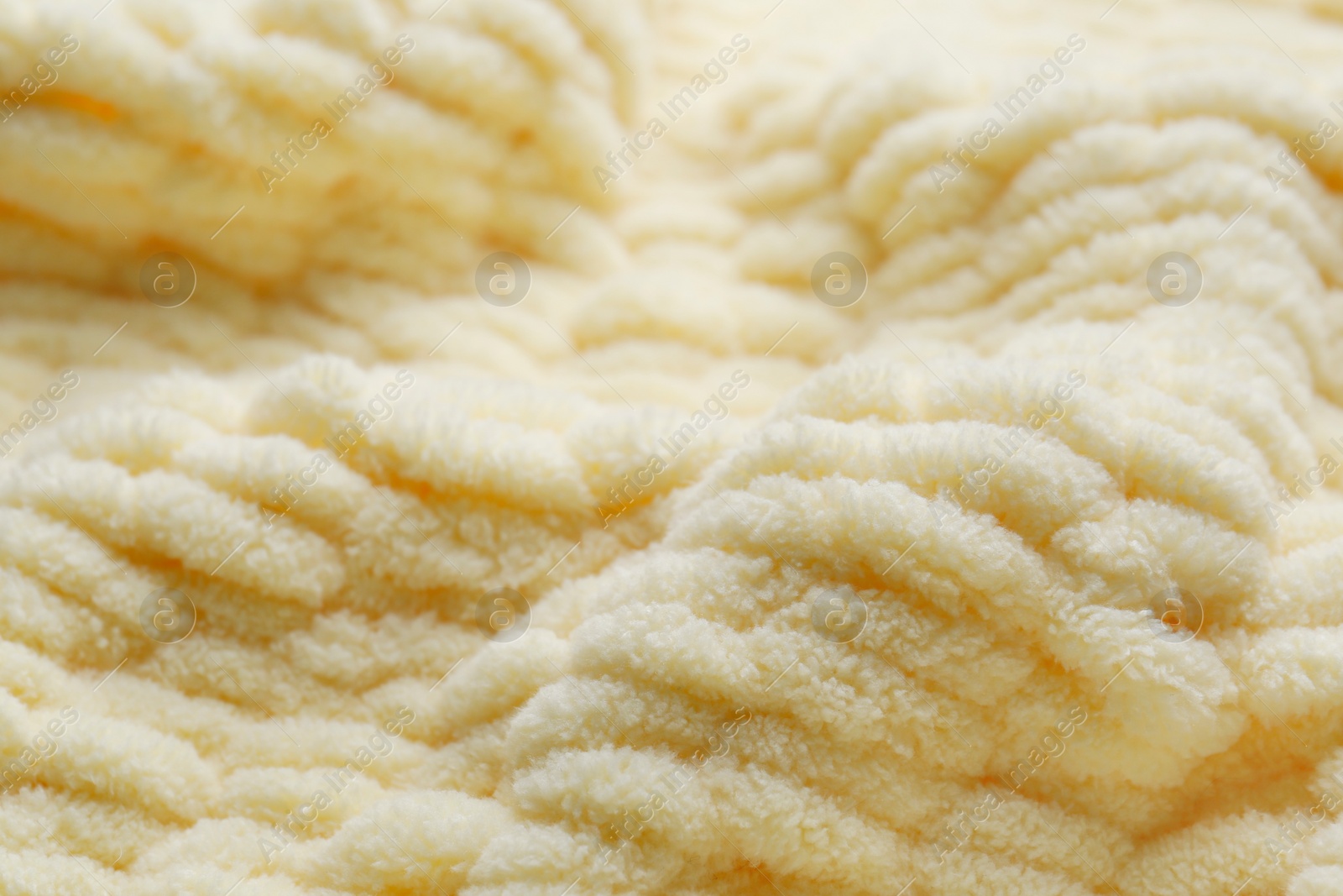 Photo of Soft beige knitted fabric as background, closeup