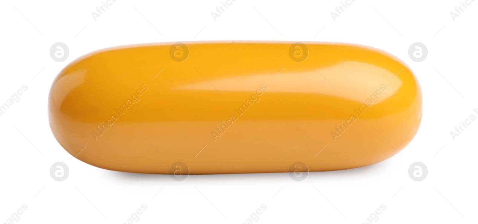 Photo of One orange pill on white background. Medicinal treatment