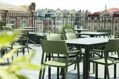 Photo of Observation area cafe. Tables and chairs on terrace against beautiful cityscape