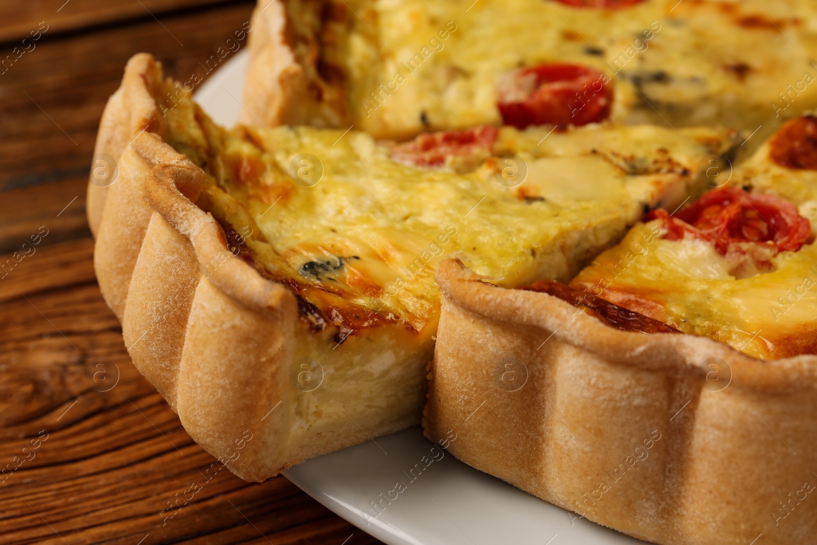 Photo of Delicious homemade cheese quiche on table, closeup