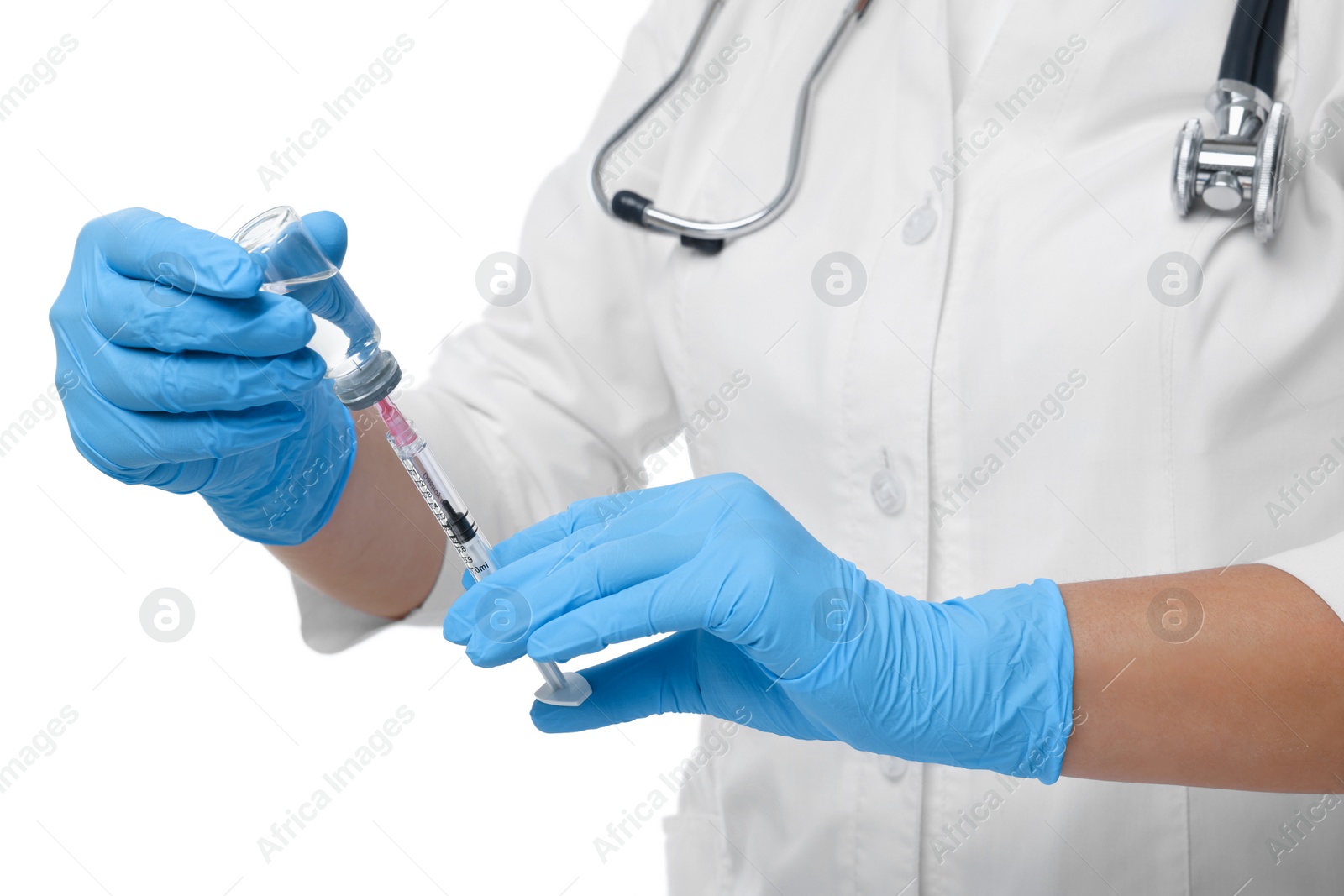 Photo of Doctor filling syringe with medication from glass vial on white background, closeup