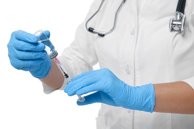 Doctor filling syringe with medication from glass vial on white background, closeup