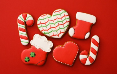 Photo of Different Christmas gingerbread cookies on red background, flat lay