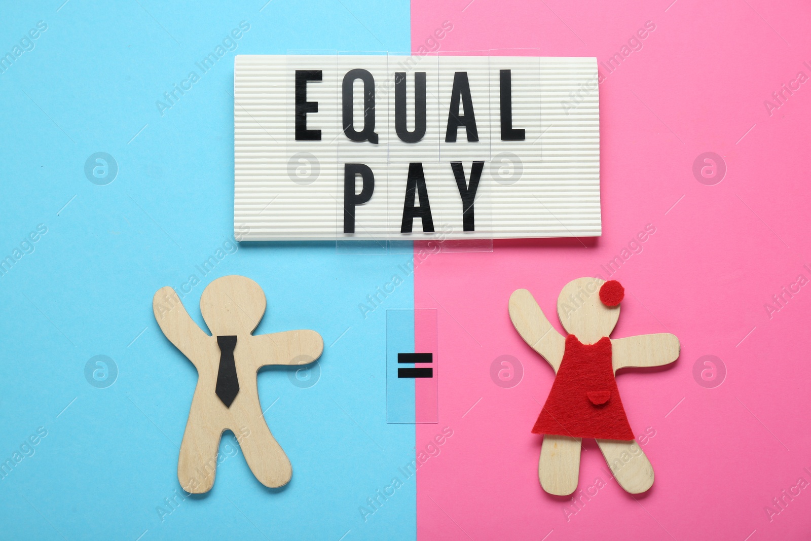 Photo of Equal pay concept. Wooden figures of man and woman on color background, flat lay