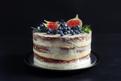 Delicious homemade cake with fresh berries on dark wooden table