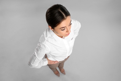 Photo of Young woman on grey background, above view