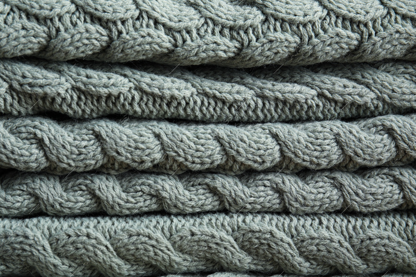 Photo of Soft knitted plaid as background, closeup view