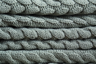 Soft knitted plaid as background, closeup view